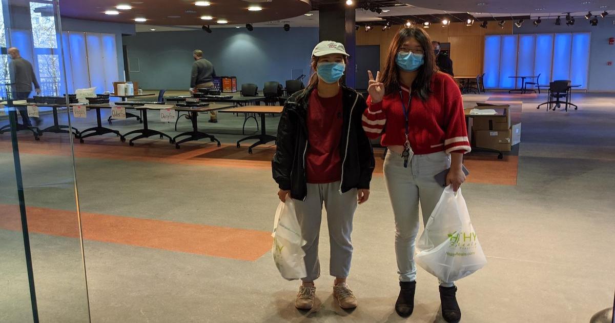 Qinwen Zhang and Lidan Mi pick up Thanksgiving meals at AU.