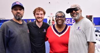 Four AU colleagues pose for a photo at Eagle Welcome. Photo by Jeff Watts.