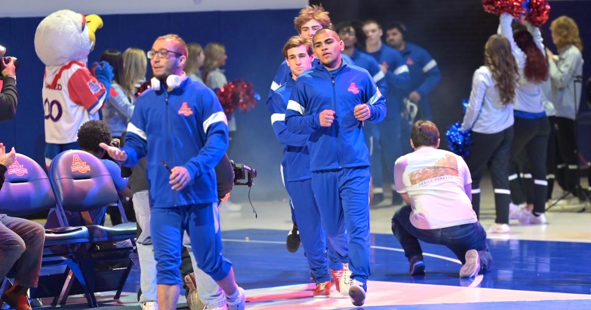 Wrestlers run out. Photo by Jeff Watts.