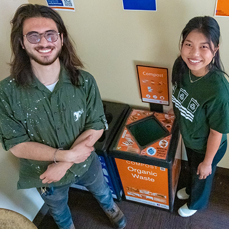 Jesse Cross and Gabby Li in front of bin