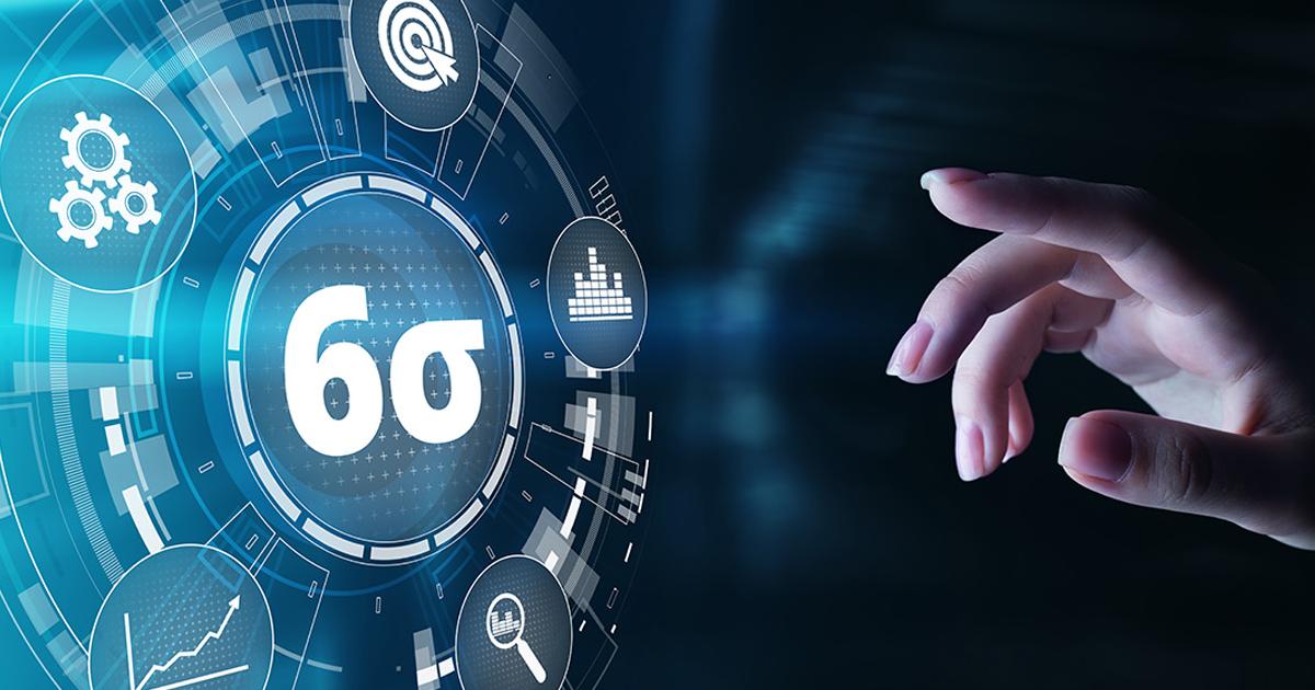 Hand reaching towards a floating image of different tools floating around a number 6 and the letter Sigma