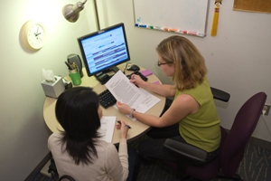 A student and a Tutor working at a desk