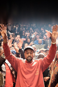 Kanye West holding his hands up