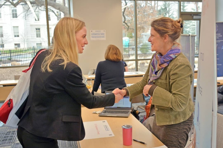 DC Internships: Intern shaking hands with an employer representative at the Internship Fair