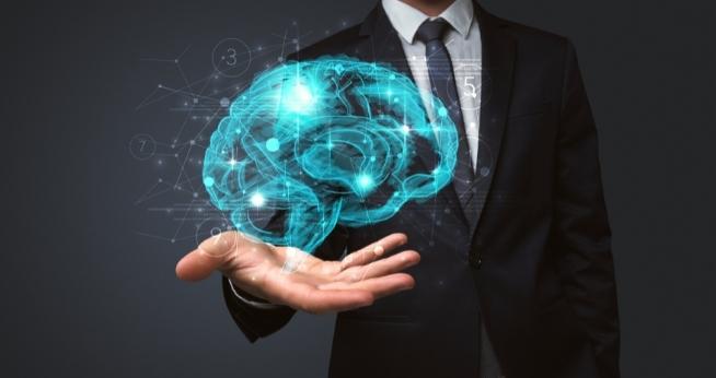 Executive Coaching | Professional man with a digital human brain floating in his hand