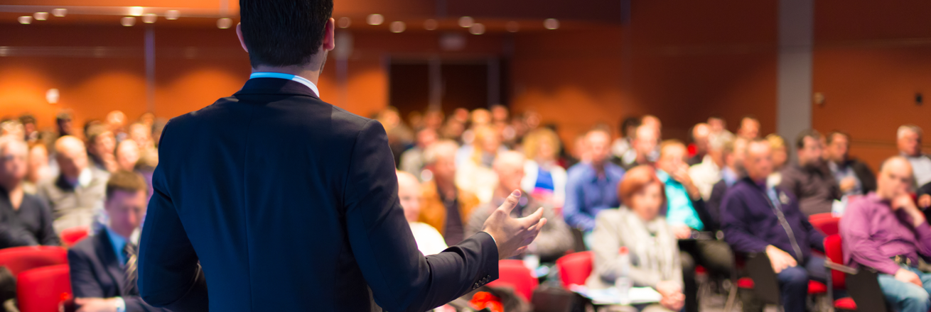 Male teacher making a presentation to an audience