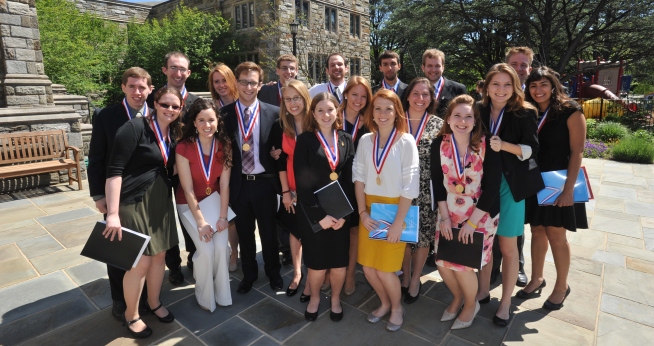 Students smile in front of camera