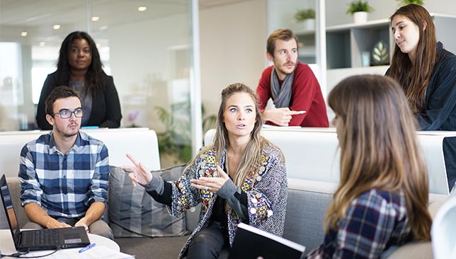 a group of individuals sitting around having a conversation