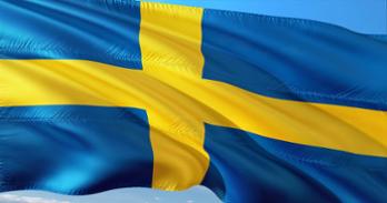 Swedish flag waving against sky blue background