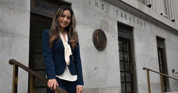 Abigail Ha, SIS/BA ’27, smiles for a photo outside the US Department of the Treasury
