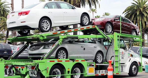 flatbed truck transports new cars