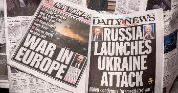 Newspapers with headlines about Russian invasion of Ukraine