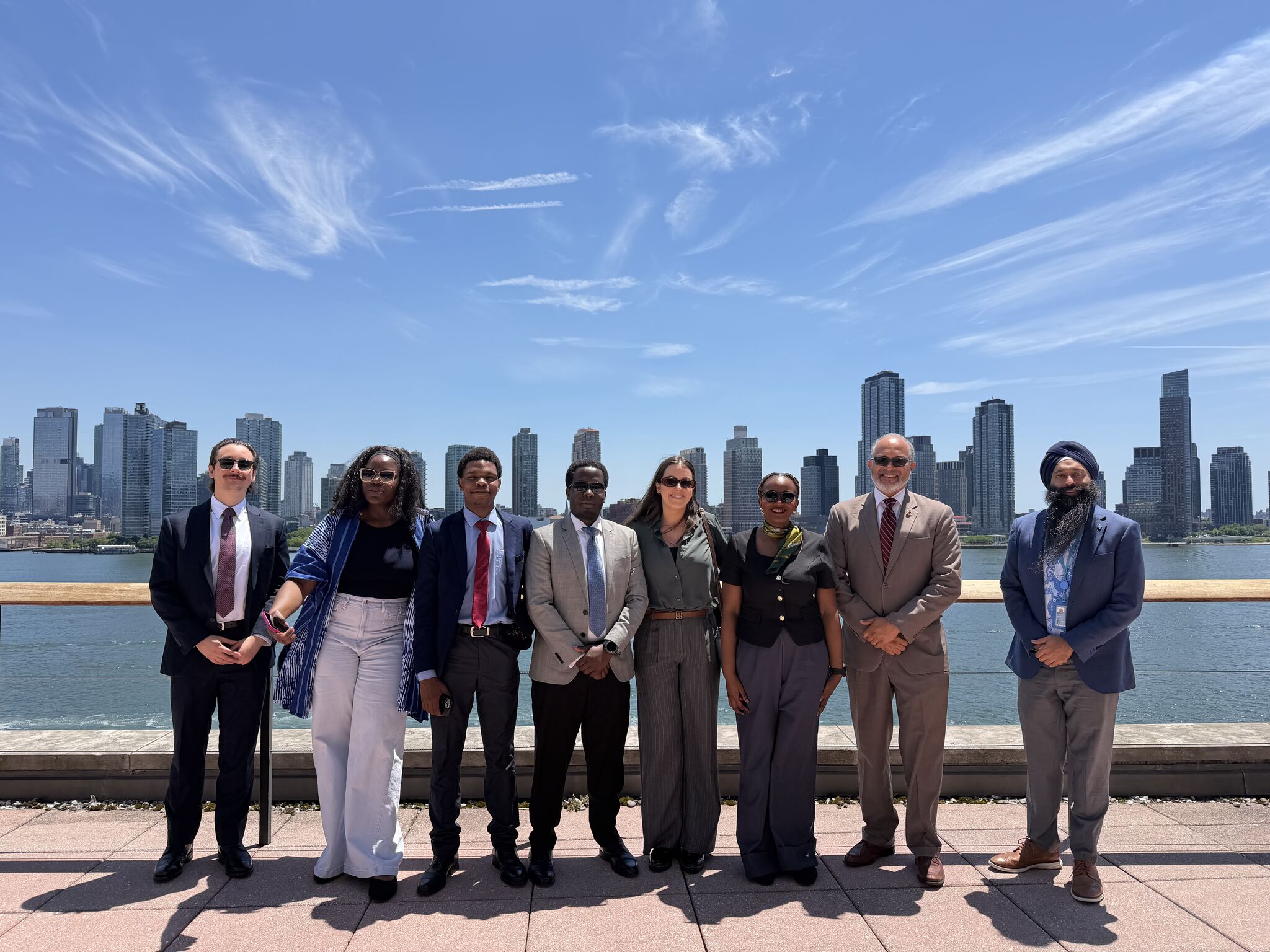 Group Outside A group of students smile for a photo with Professor Cogburn outside in New York