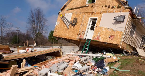 House in Michigan hit hard by a tornado is falling down with debris all around