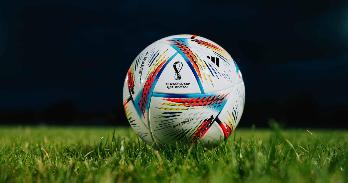 2022 Qatar World Cup soccer ball on a field