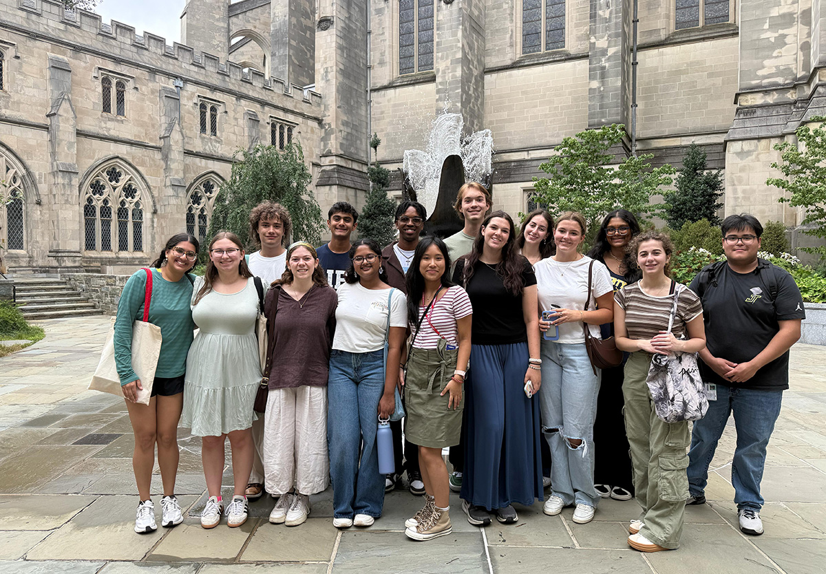 A group of Global Scholars stand smiling in front of the National Cathedral.