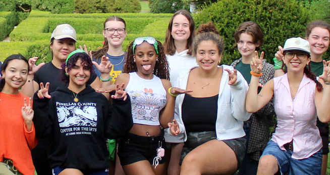 A group of Earth Scholars pose for a silly picture at an outdoor event.