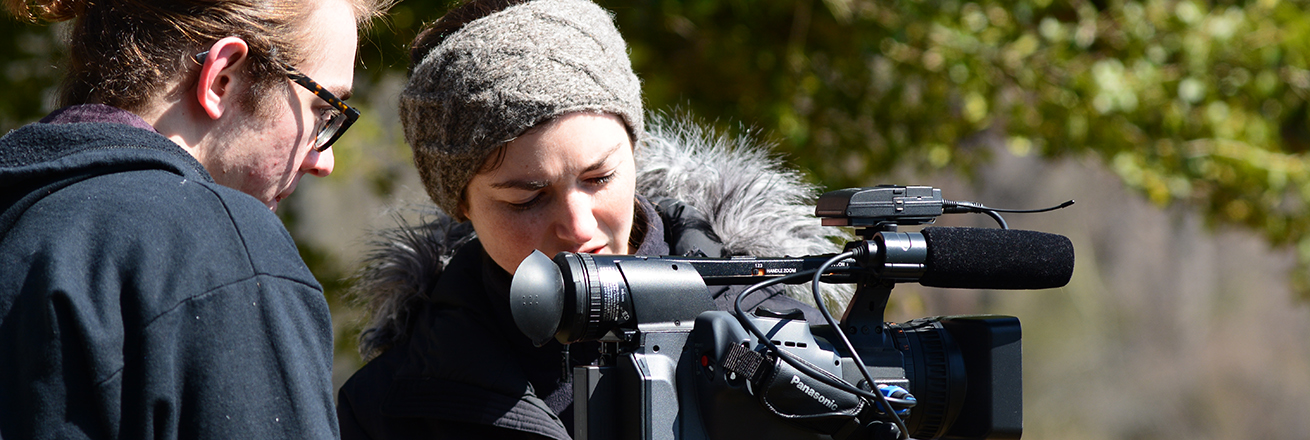 Two students positioning a camera