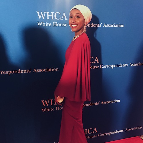 Mawal Sidi psoing at the WHCA sign