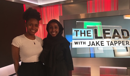 Posing for the camera in front of The Lead With Jake Tapper sign