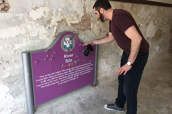 Matt Cipollone examines vandalized memorial to Emmet Till