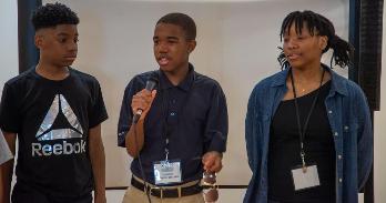 A group of students present their project at AMYF