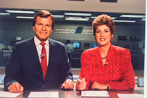 Jill Olmstead sitting at a news desk with a male co anchor