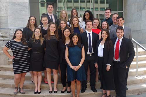 students and professor standing on steps