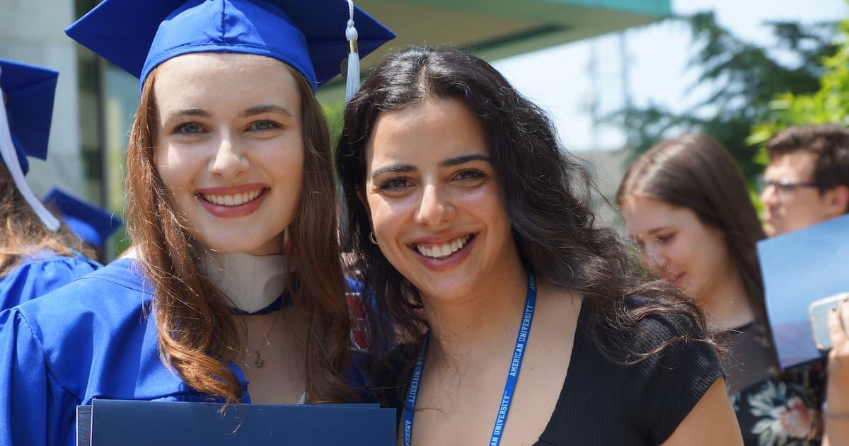 Graduate Student Jessica Newell poses with her alumni mentor Grace Ibrahim (SOC BA'15/MA'19)  on graduation day.