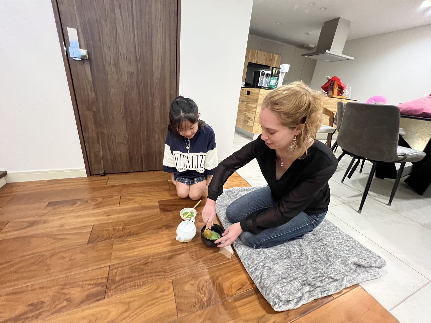 De Luca learning about a traditional tea ceremony from her host sister, Hima.