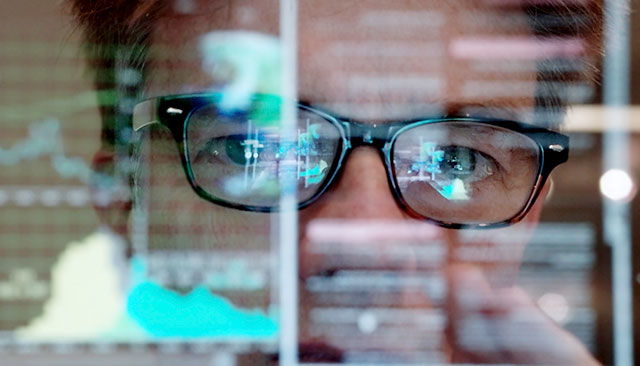 data scientist with computer reflection in glasses