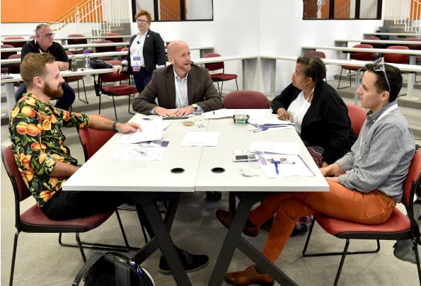 A group of attendees in discussion during session 2