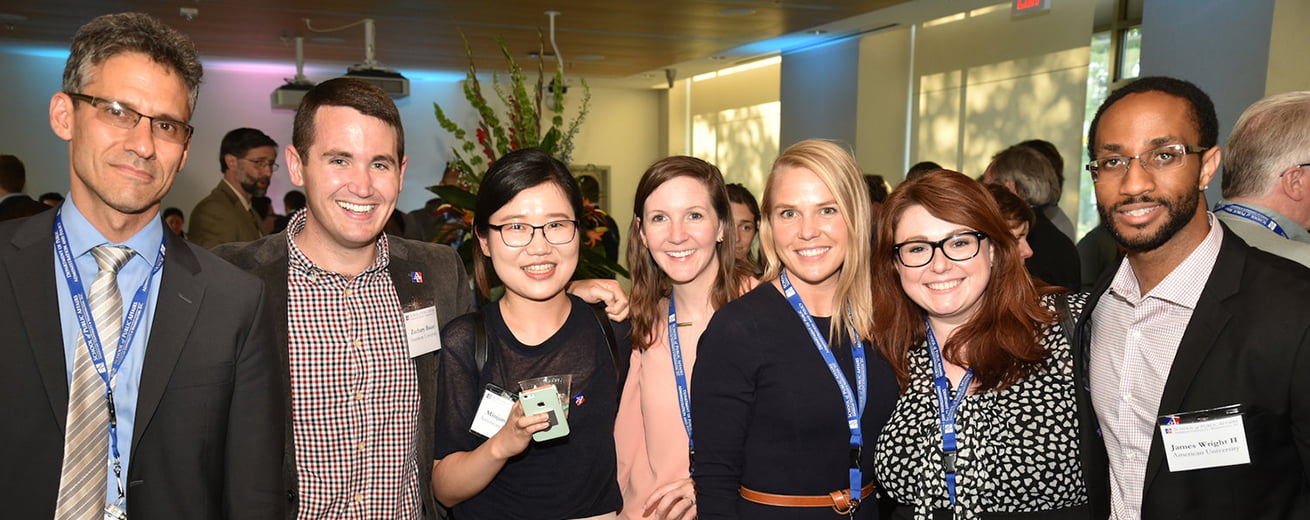 SPA Public Administration PhD Students standing together at event.