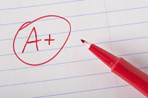 Red Pen with A+ written on paper