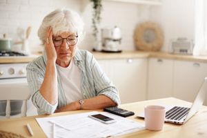 Women at table looking stressed