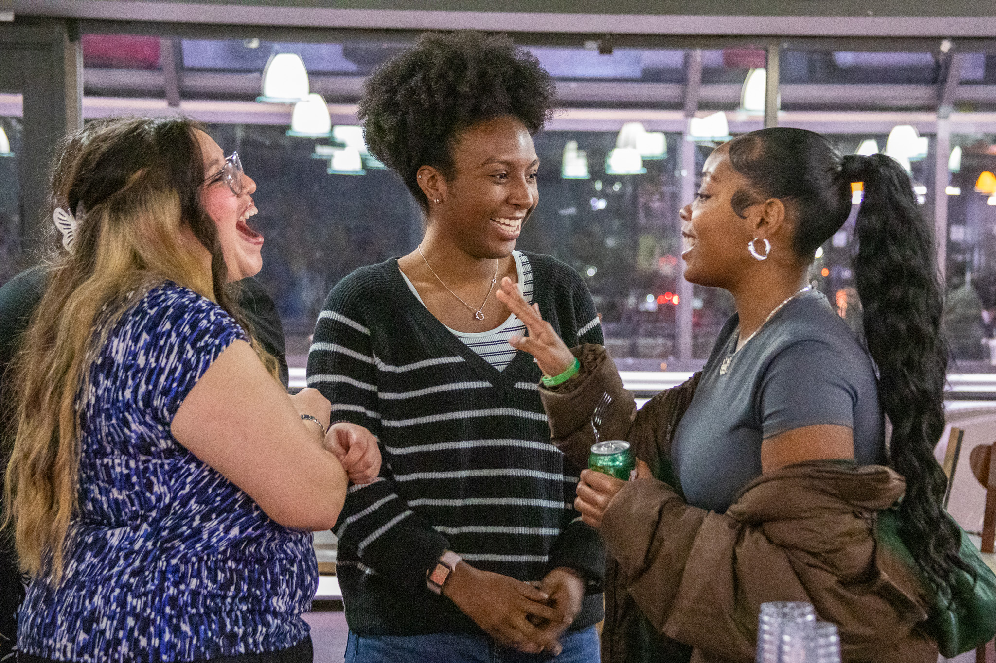Students chat in the Bridge at the Tri Alpha honor society induction.
