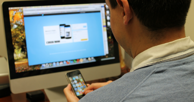 Staff member holding an iPhone
