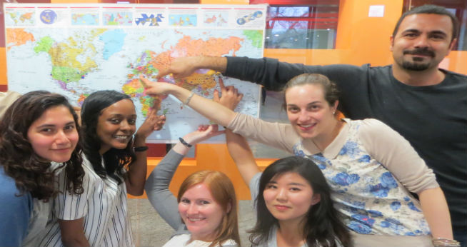 International students pointing at a map