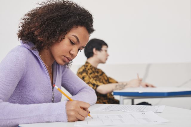 Young students concentrating on exams in a classroom, emphasizing focus and education