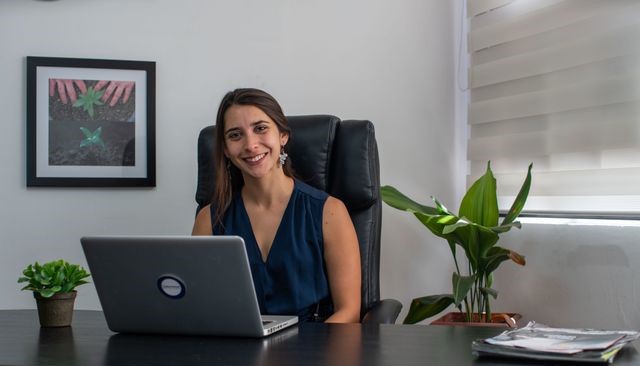 Woman smiling at desk.
