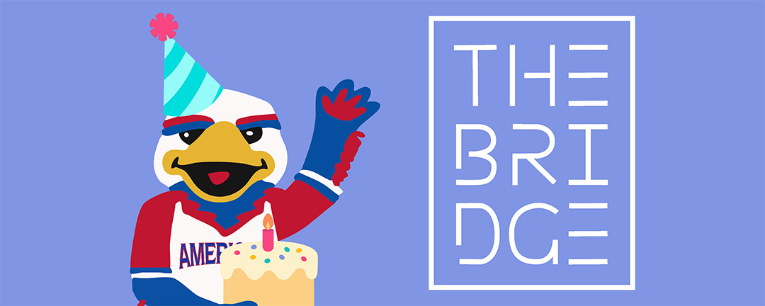 Clawed the Eagle stands in a birthday hat holding a birthday cake. Next to Clawed, there is the logo for the Bridge Cafe. The background is a periwinkle blue.