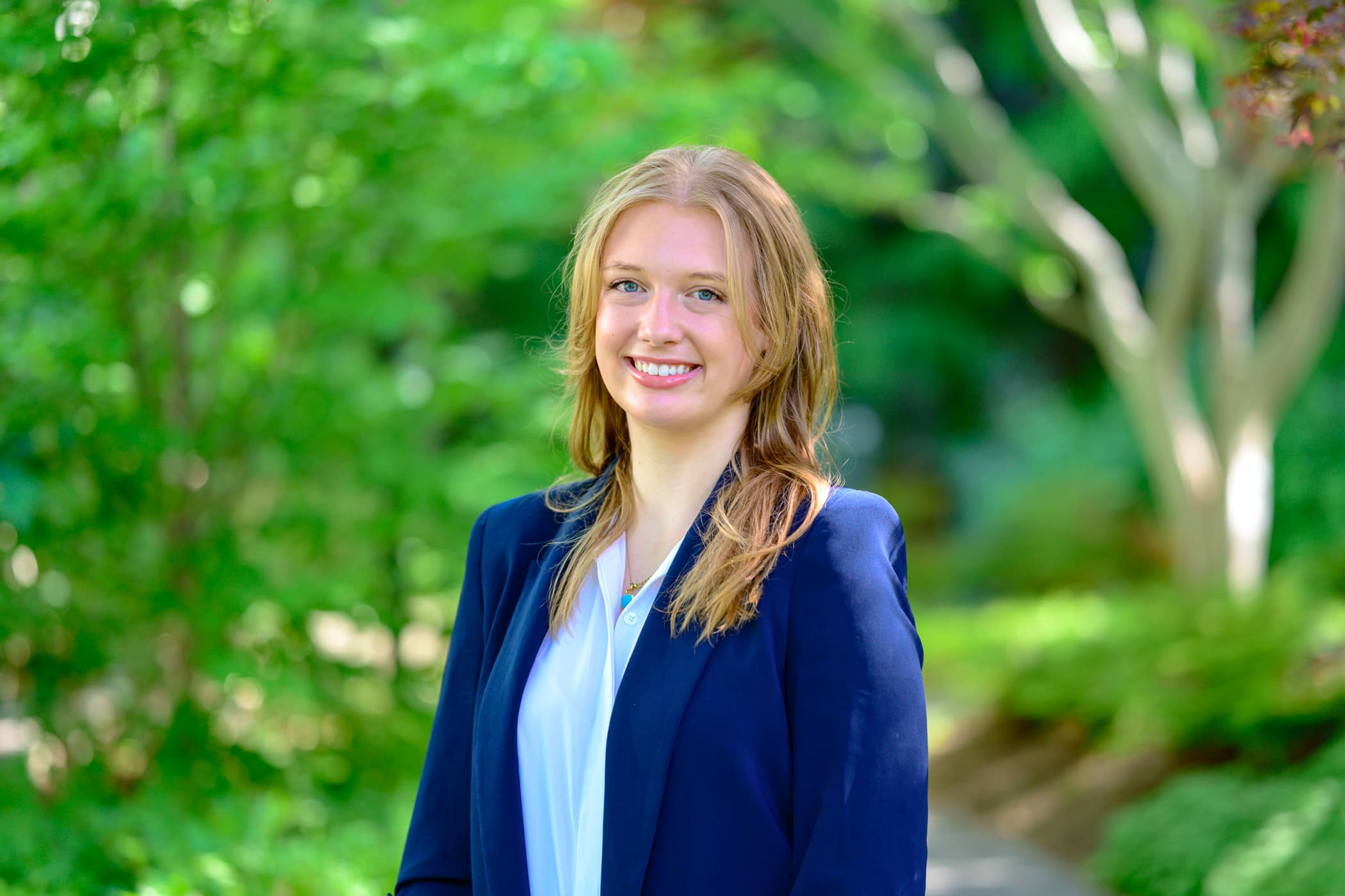 Student Maeve Devereux stands outdoors.