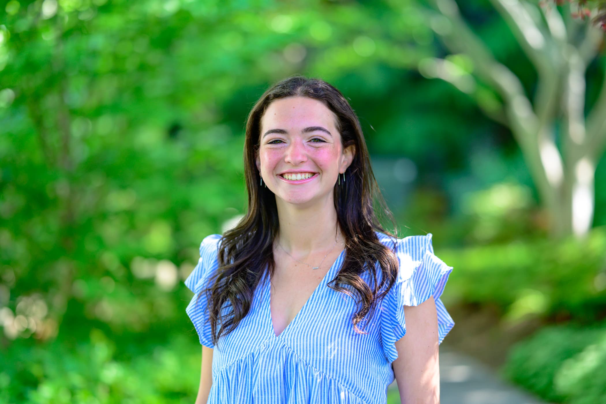 Student Nicole LeVee stands outdoors.