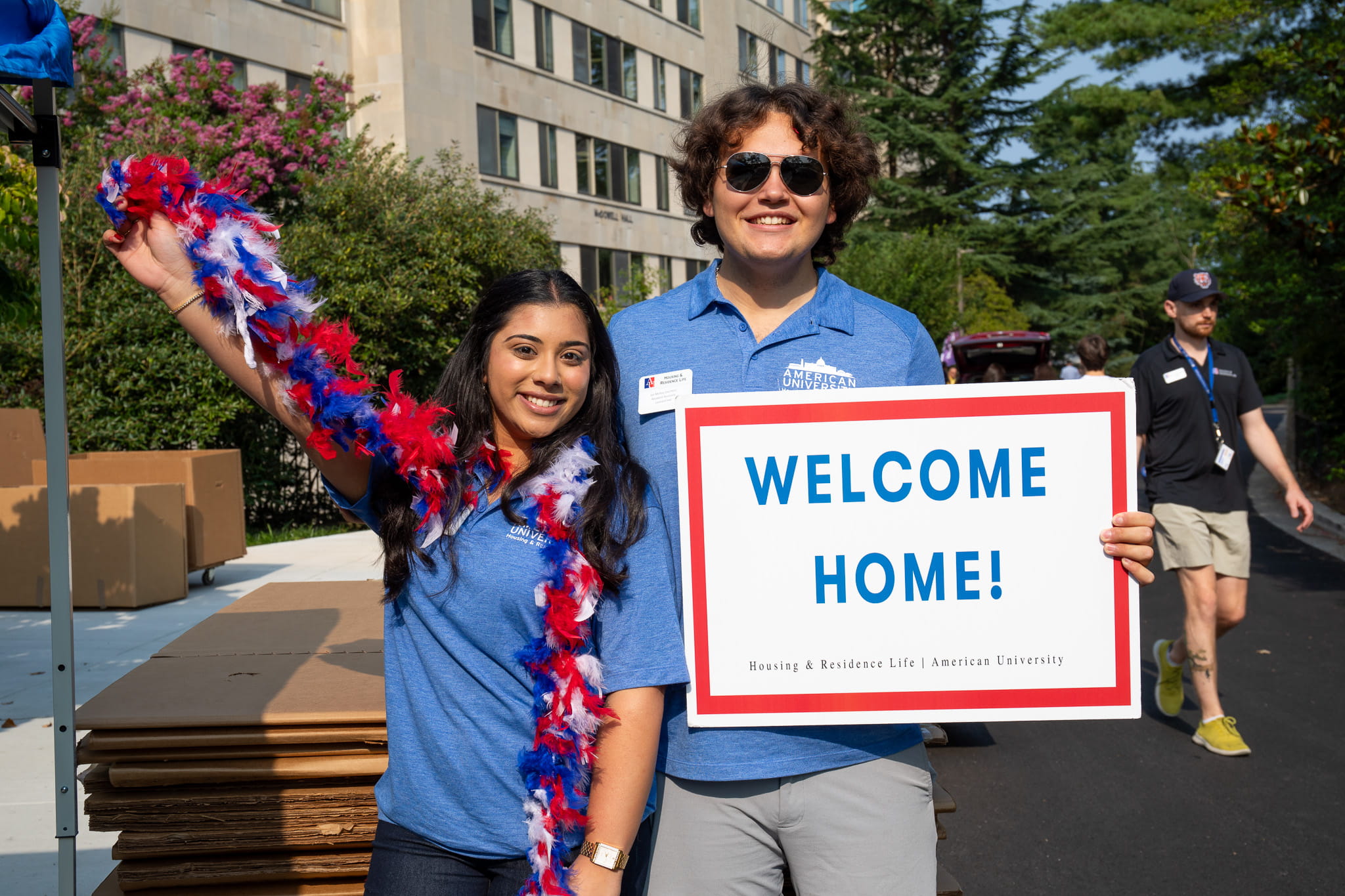 Students holding a welcome home sign.