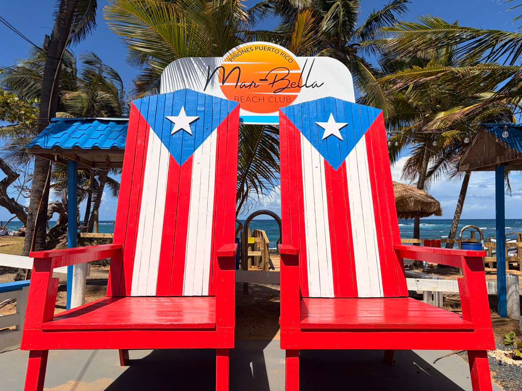 Two beach chairs painted to resemble the Puerto Rican flag.