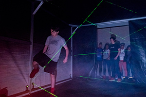 student navigates laser maze student navigates laser maze