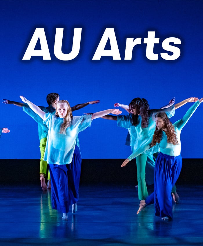 Dancing students on a stage with the text "AU Arts" on top of it.