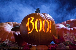 A jack-o-lantern glows with the word 