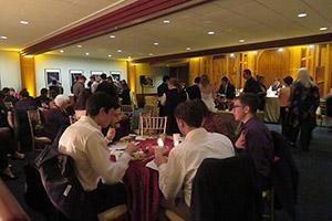 Attendees sit at tables during the screening of 12