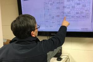An AU facilities employee monitoring energy use
